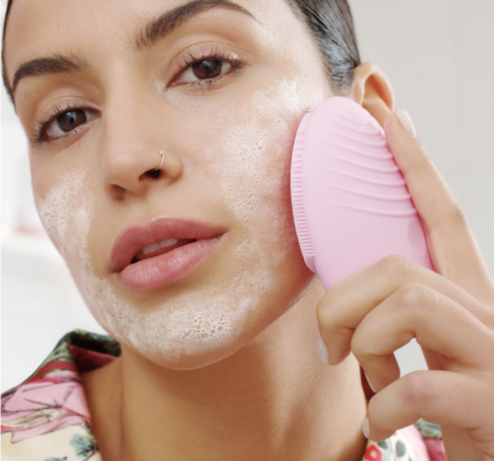 model using foreo on their cheek