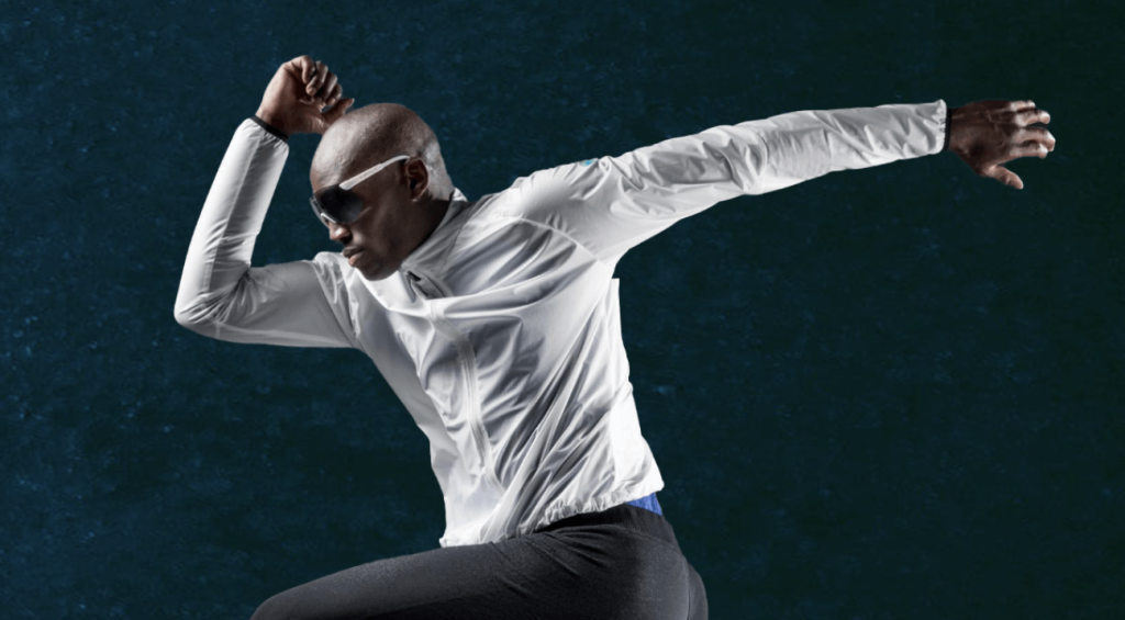 man with goggles running in the air wearing uyn