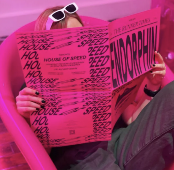 woman reading saucony endorphin magazine
