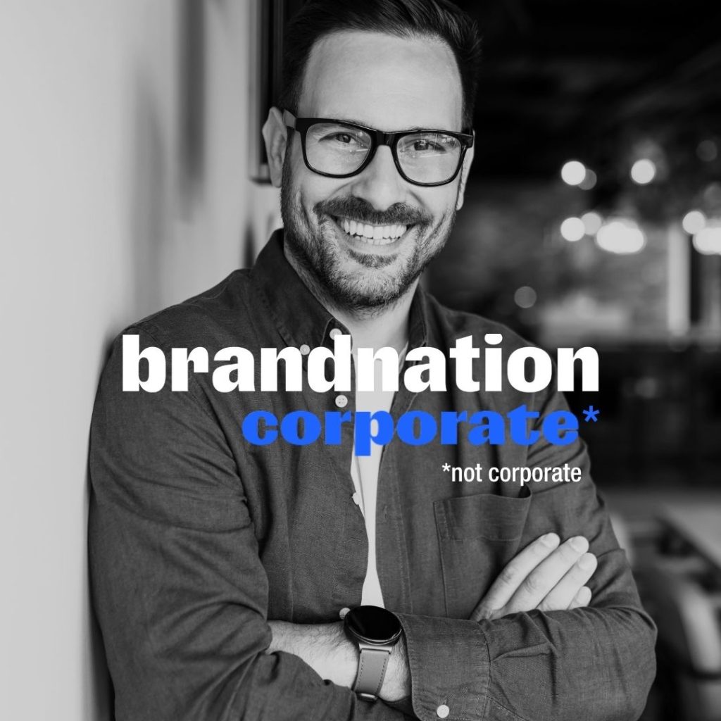 Image of business casual man smiling with Brandnation text overlay stating 'corporate not corporate'